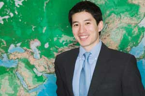 Man in front of a world map.